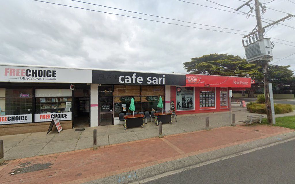 Cafe Sari on Church Street Cowes with outdoor seating, black signage and neighbouring shops